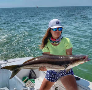 Woman Holding Cobiaon Boat Wallpaper