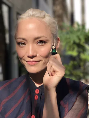 Woman Holding Lego Figure Outdoors Wallpaper