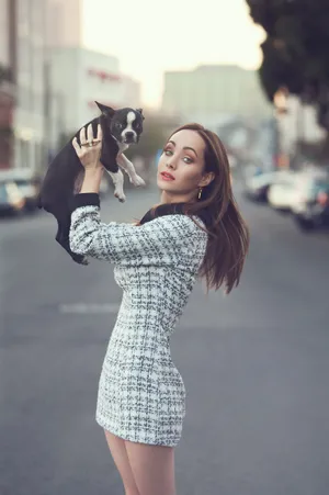 Woman Holding Puppyon City Street Wallpaper