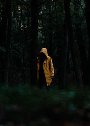 Woman In A Bright Yellow Raincoat On A Rainy Day Wallpaper