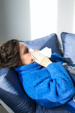 Woman In Robe Holding Sneeze Wallpaper