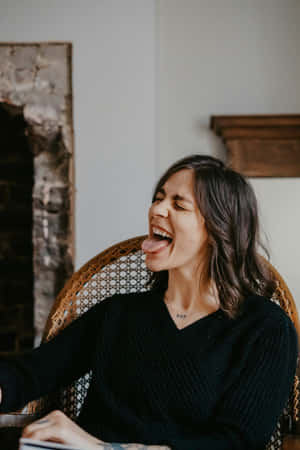 Woman Laughing In Wicker Chair Wallpaper