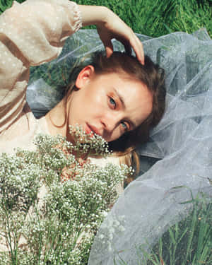 Woman Lyingin Grasswith Flowersand Tulle Wallpaper