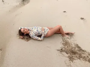 Woman Lyingon Sand Dunes Wallpaper