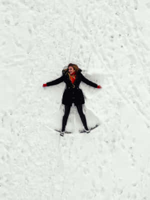 Woman Making A Snow Angel Wallpaper