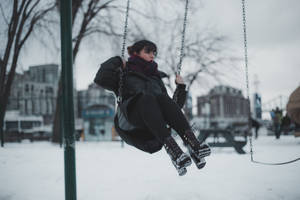 Woman On Playground Swing Wallpaper