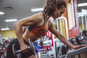 Woman Performing Weightlifting Wallpaper