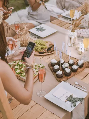 Woman Taking Photo Of Bachelorette Party Food Wallpaper
