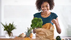 Woman Unpacking Grocery Items Wallpaper