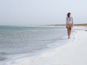 Woman Walking On Dead Sea Shore Wallpaper