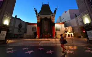 Woman Walking Outside Graumans Chinese Theatre Wallpaper