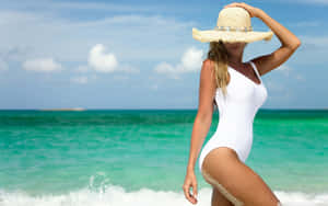 Woman Wearing A Beach Hat On A Sunny Day Wallpaper