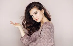 Woman Wearing A Mauve Knit Sweater Wallpaper