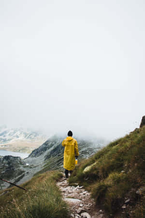 Woman Wearing A Vibrant Yellow Raincoat Wallpaper