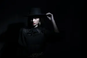 Woman With Hat On Black Tablet Wallpaper