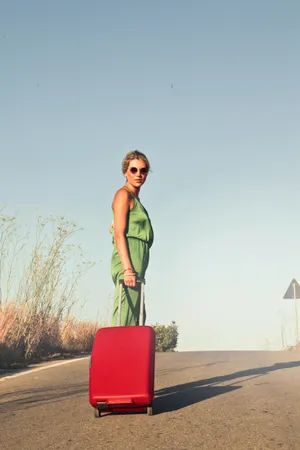 Woman With Suitcase On Road.jpg Wallpaper
