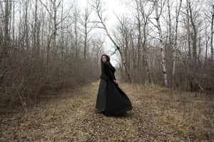 Womanin Black Dressin Woods Wallpaper