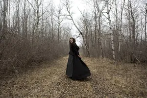 Womanin Black Dressin Woods Wallpaper