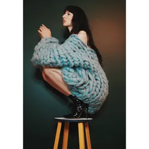 Womanin Chunky Blue Sweateron Stool Wallpaper