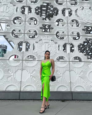 Womanin Green Dress Against Geometric Backdrop Wallpaper