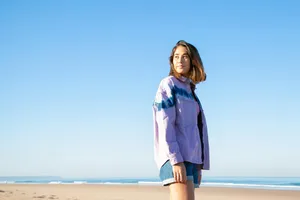 Womanin Purple Jacketat Beach Wallpaper