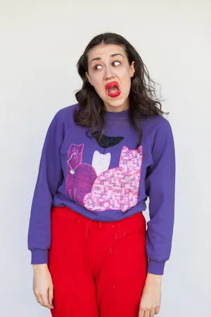 Womanin Purple Sweater Red Pants Making Face Wallpaper