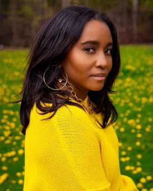 Womanin Yellow Sweater Fieldof Flowers Wallpaper