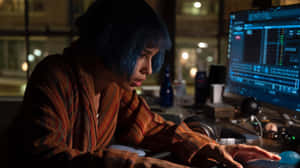 Womanwith Blue Hair Workingat Computer Night Wallpaper