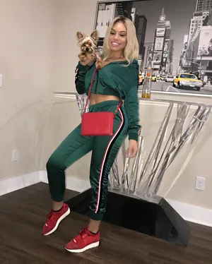 Womanwith Dogin Stylish Outfit Wallpaper