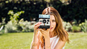 Womanwith Vintage Camera Outdoors Wallpaper