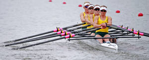 Women's Championship Rowing Team In Action Wallpaper