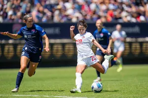 Women Soccer Midfielder Action Shot Wallpaper