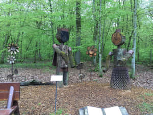 Wooden Sculpturesin Forest Bettembourg Wallpaper