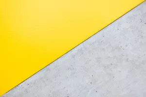 Working Behind A Bright Yellow Computer Reveals A Creative Mindset. Wallpaper