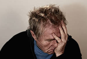 Worried Elderly Man In Deep Thought Wallpaper