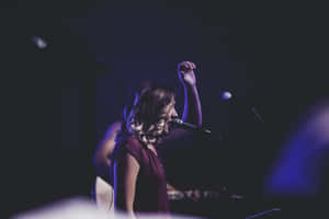 Worship_ Leader_ Singing_ On_ Stage.jpg Wallpaper