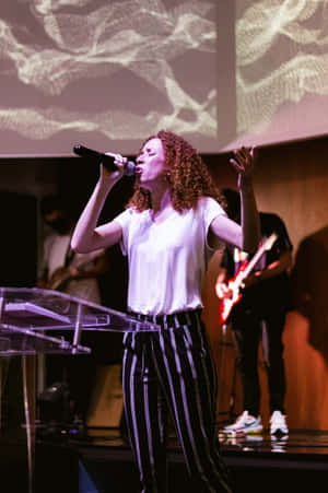 Worship_ Leader_ Singing_ On_ Stage.jpg Wallpaper