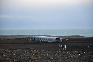 Wrecked Plane On Black Sand Wallpaper