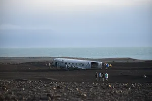 Wrecked Plane On Black Sand Wallpaper