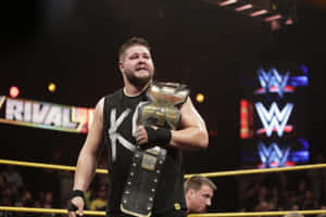 Wrestler Kevin Owens Hold The Wwe Nxt Title Wallpaper