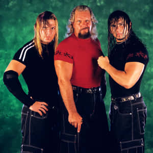 Wrestling_ Trio_ Posing_ Green_ Background Wallpaper