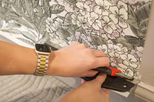 Wrist Wearing Smartwatch While Using Tools.jpg Wallpaper