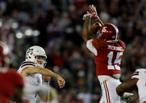 Xavier Mc Kinney Defensive Play During Game Wallpaper