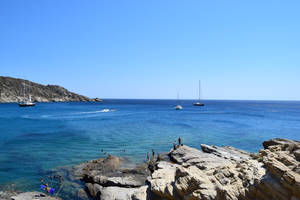 Yachts On Rocky Coastline Ios 13 Wallpaper