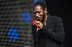 Yasiin Bey Performing At An International Stage Wallpaper