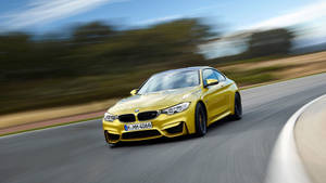 Yellow Bmw M Car Speeding Up Wallpaper