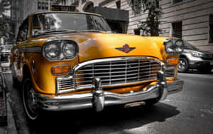 Yellow Cab On City Street In Urban Environment Wallpaper