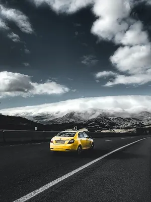 Yellow Car Mountainous Roadscape Wallpaper
