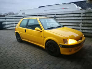 Yellow Peugeot106 Side View Wallpaper