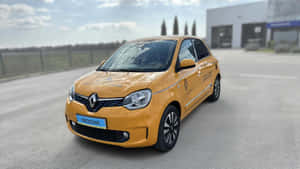 Yellow Renault Twingo Parked Outdoors Wallpaper